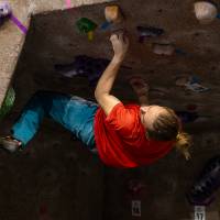 a competitor attempting to scale through the roof of the cave. spoiler, he doesn't make it.